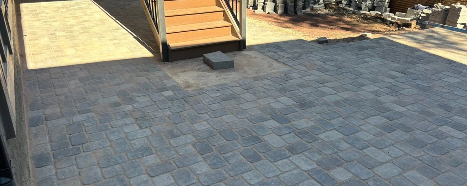 A finished paver patio and landscaped backyard