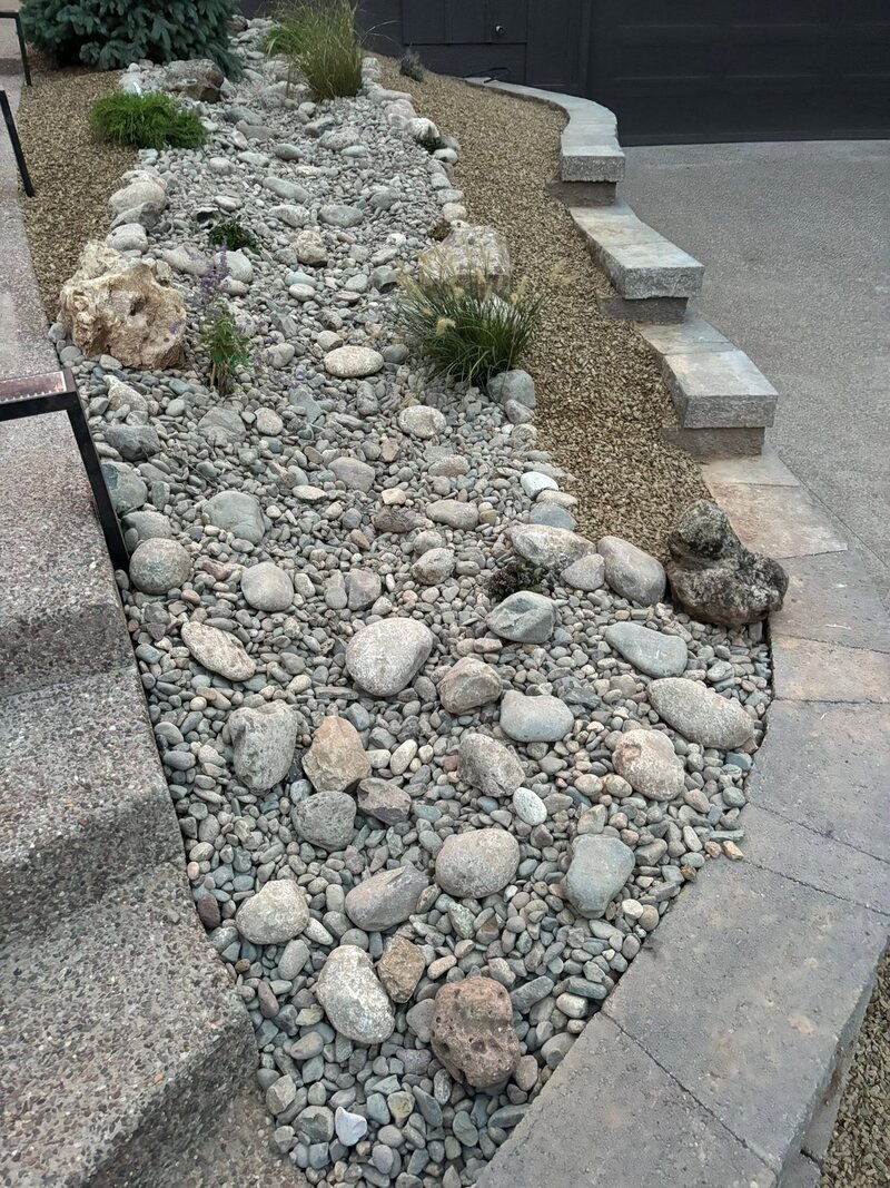 Dry riverbed rock landscaping with steps