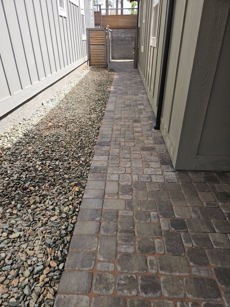 Gravel side yard with metal fencing